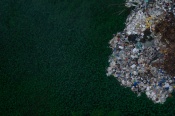 An aerial view of discarded waste spreading over a marshy land filled with taro plants. I was awarded the first runner in the Nature inFocus Photography Awards 2020 for this image.